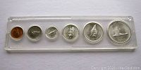 Front view of the 1967 Canadian proof-like coin set in plastic holder showing reverse sides with commemorative designs of animals and Canadian symbols.