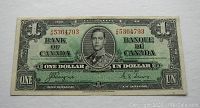 Front of the 1937 Canadian $1 bill with portrait of King George VI and Coyne-Towers signatures.