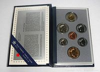 Front view of specimen coin set in original Royal Canadian Mint holder showing seven coins in a blue presentation case with an information leaflet.