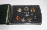 Front view of the 1990 Royal Canadian Mint proof set with seven coins including uncirculated specimens and gold-tone coins in original holder.