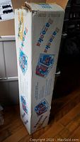 Original box for 1990 O-Pee-Chee Bazooka NHL hockey card uncut sheet, tall and rectangular with Bazooka branding and graphics.
