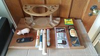 Lot contents including wooden pipe holder, pig shaped lighter, cigar cutter, packs of pipe cleaners and cigar tubes.