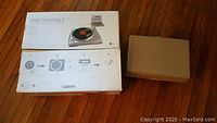 Photo of USB Turntable box and a plain brown box containing the General Electric portable record player.