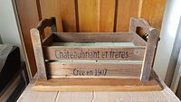 Front view of wooden crate showing French brand name and year created