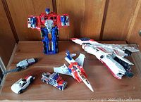 Grouped photo of all Transformers toys including Optimus Prime and various vehicle forms