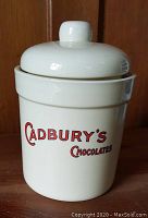 Front view of ceramic Cadbury's Chocolates storage canister with lid showing the logo