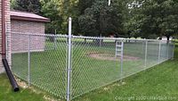 Installed 50ft length of 4ft high galvanized chain link fencing attached to posts