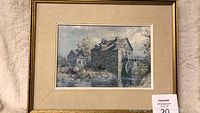 Framed print showing a scenic stone mill with water wheel and surrounding vegetation.