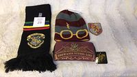 Harry Potter beanie, two Hogwarts scarves with emblems, and Gryffindor patch