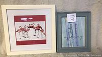 Both framed decor pieces together, showing flamingo print with white frame and inspirational 'BE AMAZING' artwork with rustic gray-blue frame