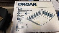 Box front showing Broan 678 Ventilation Fan with Light model, noise rating, power rating, and illustration.
