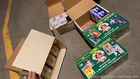 Overhead shot of multiple sealed baseball card boxes and open box.