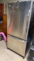 Front view of stainless steel Maytag refrigerator with bottom drawer freezer.