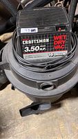 Photo of the top of the wet dry vac showing Craftsman branding, peak horsepower of 3.5, 16 gallon capacity, and other specifications.