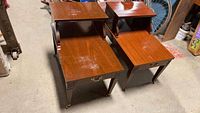 Pair of two-tier wooden side tables by Mersman, showing the full tops and drawer fronts