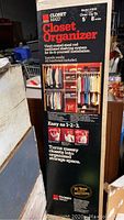 Photo of the unopened box displaying Closetmaid Closet Organizer Model 1608 packaging with closet setup image and product details.