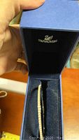 Swarovski branded blue jewelry box holding the crystal bracelet.