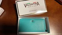 Valentina wallet in box showing front and logo with box lid