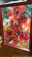 Full view of the vivid floral watercolor painting in frame showing bright colors and floral details.