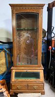 Full front view of the wooden gun display cabinet with glass door showing etched pheasants and brass hardware