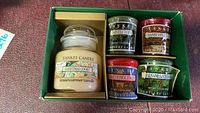 Photo of 5 Yankee Candle housewarmer and votive candles in holiday scents in green box