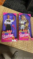 Front view of Hollywood Hair Barbie and Ken dolls in sealed original packaging with accessories visible.