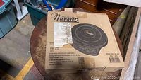 Box of NuWave 2 Induction Cooktop shows product branding, model number, and handling instructions.