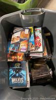 One bin filled with assorted DVDs showing covers including The Wolves and others.