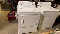 Side view of the Roper electric washer and dryer together showing their size and condition.