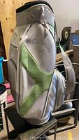 Side view of white and light green Callaway golf bag with brand name and green accent patterns
