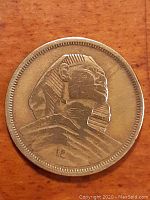 Obverse side of Egypt 10 Millimes coin showing large sphinx profile.