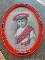 Photo of the vintage red oval framed advertisement featuring a lithograph of a child and product name.