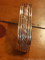 Close-up image of the bracelet highlighting the twisted rope design and dual metal tones.