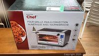 Boxed Master Chef digital convection toaster oven with rotisserie showing front view, product image, and pizza image on side.