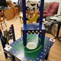 Overall view of folk painted table with two chairs