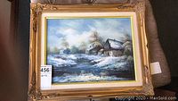 Full view of the framed 16x12 winter landscape painting with snow and rustic houses
