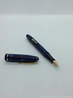 Uncapped pen and cap displayed side by side on white background