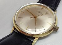 Close-up of dial showing gold hour markers, hands, and “Porta” signature