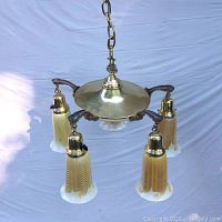 Full view of 5-light brass chandelier with five iridescent Quezal glass shades suspended by decorative arms