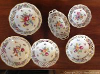 Top-down view of all six pieces on wood table