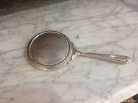 Full view of Birks sterling silver antique vanity mirror with handle and detailed back engravings.