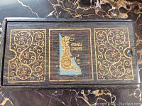 Closed bamboo box with gold dragon design and ‘Pung Chow’ text on lid