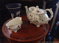Photo of Hammersley Dogwood Blossom teapot and sugar bowl with Wedgwood blue jasperware vase on a wooden table