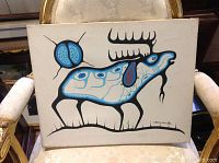 Full view of stretched canvas painting showing stylized deer motif