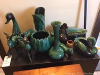 Initial overview of all the Blue Mountain Pottery items displayed showing various animal figurines and vases.