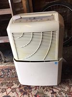 Front view of the Maytag dehumidifier showing the white grille and unit body.