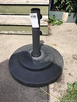 Photo of the full umbrella stand showing round wide base and central pole with tightening knobs