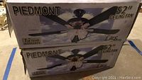 Two boxed Piedmont 52 inch ceiling fans stacked, showing brand and size