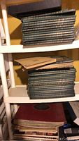 Stack of black boxed LP collections on shelving unit, likely classical music sets or multiple-album boxed editions.