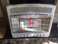 Front view of the heater showing the metal protective grid and heating element inside.